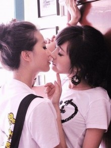 Girls kissing in doorway Girls kissing in doorway