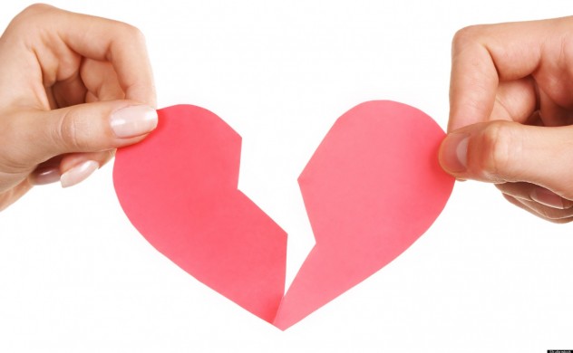 Two women breaking a heart in half