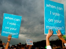 Protestors hold signs supporting same-sex marriage