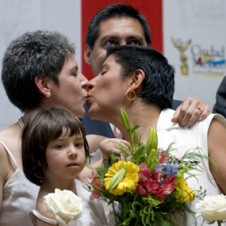 Mexican lesbian couple kissing.