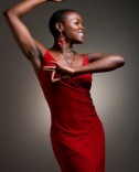 woman with shaved head in a red dress