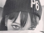 Rhianna wearing a Principle 6 beanie