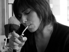 Woman lighting cigarette