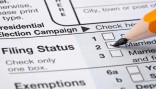 Pencil checking married on tax form