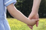 Woman holding little girl's hand