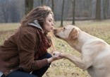 Woman kissing dog
