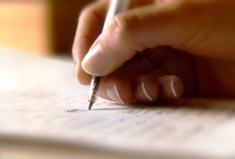Woman's hand writing with pen