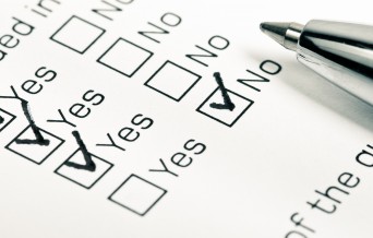 Close up of yes and no checkboxes with pen