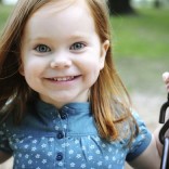 Young girl on swing smiling